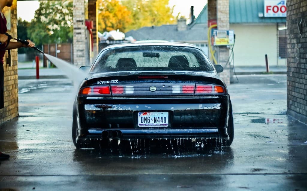 Black sports car being pressure-washed at Luxury Car Care in Bidar